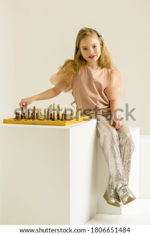 Similar – lifestyle shot of smart kid girl playing checkers at home