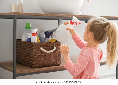 Little Girl Playing With Cleaning Supplies At Home