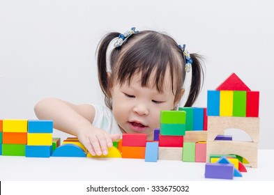 Little Girl Playing Colorful Wood Blocks