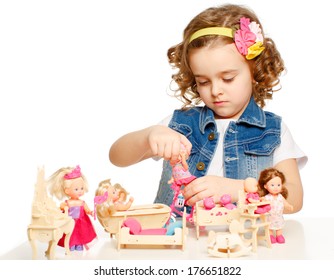 Little girl playing with dolls