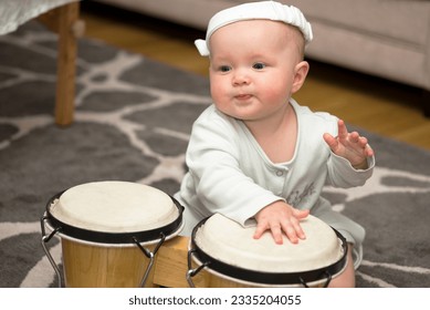little girl playing the drum - Shutterstock ID 2335204055