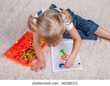 little girl playing with education mosaic pins toy