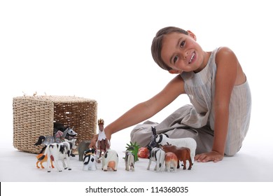 Little Girl Playing With Farm Animal Toys