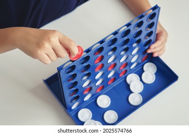 Little Girl Playing Four In A Row, 4 In Line Game, Game Education Toys For Kids.