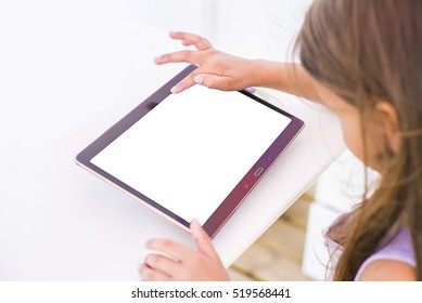 Little girl playing game on tablet. Device white screen mockup with kid.  - Powered by Shutterstock