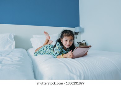 Little Girl Playing Ipad Table On Bed