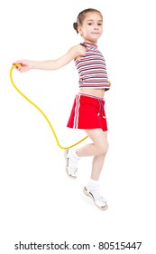Little girl playing with jumping rope. Isolated on white