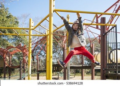 Little Girl Playing With Monkey Bars