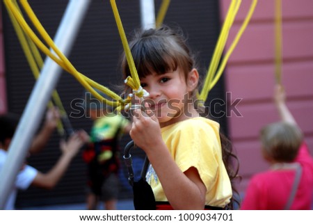 Similar – Image, Stock Photo Bungee jumping at trampoline. Little girl bouncing on bungee jumping in amusement park on summer vacations