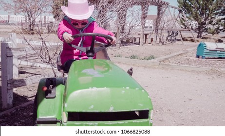 Little Girl Playing On Playground At The Urban Farm.