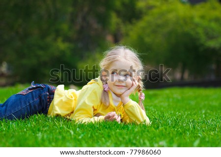 Similar – Littel girl sitting on grass looking curious