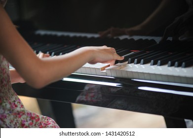 Little Girl Playing Piano. Happy Little Asian Girl Playing Piano