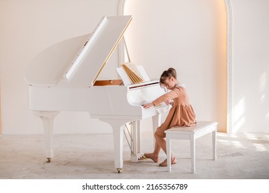 Little girl playing piano indoors - Powered by Shutterstock