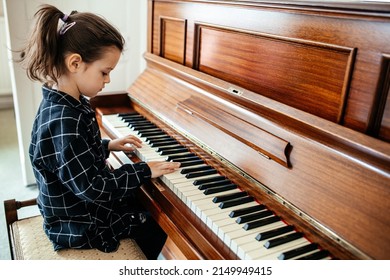 Little Girl Playing The Pianto, Child Learning How To Play Musical Instrument