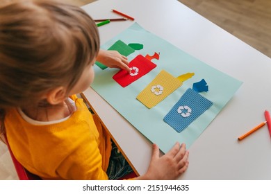 Little girl playing with poster of garbage containers for sorting at kindergarten or primary school. Recycling education concept. - Powered by Shutterstock