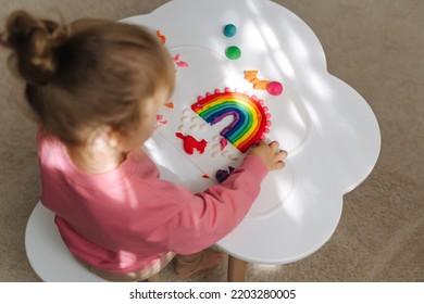 A Little Girl Playing With Rainbow From Play Dough For Modeling. Art Activity For Kids. Fine Motor Skills. Sensory Play For Toddlers.	