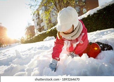 Little Girl Playing With Snow In The Floor