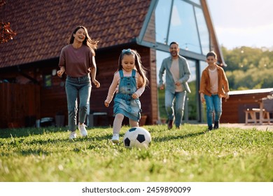 Little girl playing soccer with her family during spring day. Copy space. - Powered by Shutterstock