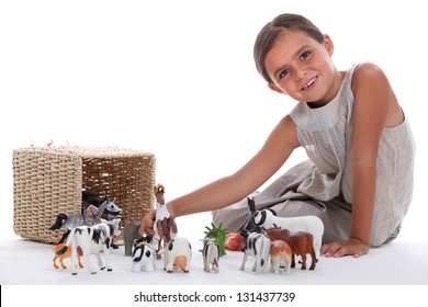 Little Girl Playing With Toy Animals