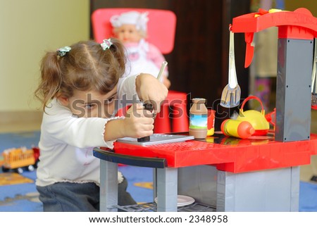 Similar – Baby girl playing with hair clips sitting in the floor