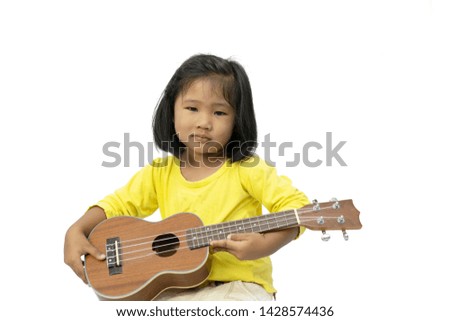 Little girl playing ukulele on white background