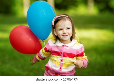 little girl plays with balloons
