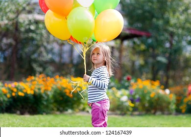 little girl plays with balloons
