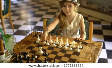 Similar – Image, Stock Photo lifestyle shot of smart kid girl playing checkers at home