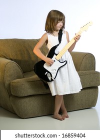 A Little Girl Plays A Guitar For A Popular Video Game