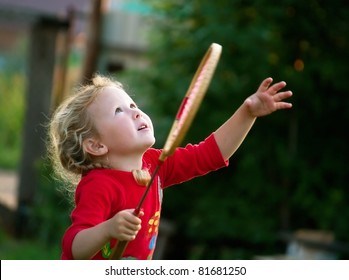The little girl plays with a racket in badminton. Shallow DOF