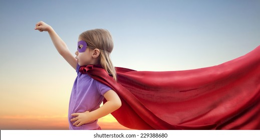 a little girl plays superhero