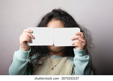 Little Girl Portrait Holding Two Flash Card In Front Of Face, Preschooler Educational Material Learning Objects. Flash Cards Selection Path Included.