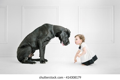 Little Girl Posing Against A Big Dog