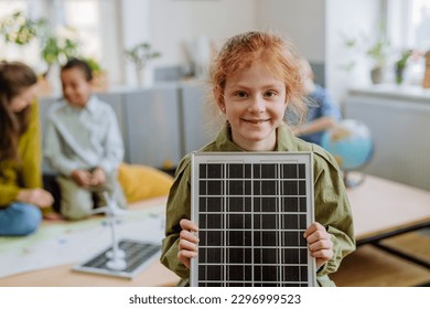 Little girl posing with solar panel during a school lesson. - Powered by Shutterstock