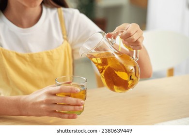 Little girl pouring apple juice into glass in kitchen, closeup - Powered by Shutterstock