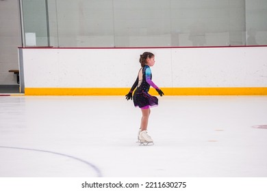 Little Girl Practicing Before Her Figure Skating Competition At The Indoor Ice Rink.