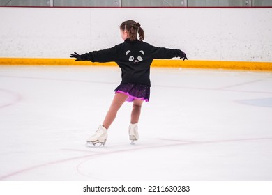 Little Girl Practicing Before Her Figure Skating Competition At The Indoor Ice Rink.