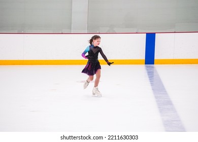 Little Girl Practicing Before Her Figure Skating Competition At The Indoor Ice Rink.