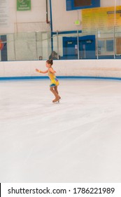 Little Girl Practicing For Figure Skating Competition On Indoor Iceskating Rink.