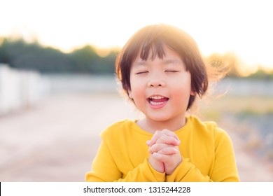 Little Girl Praying In The Morning.Worship And Pray.Asian Kid Girl Hand Praying For Thank GOD,Hands Folded In Prayer Concept For Faith,spirituality And Religion.Give Thank, Thankful, Thanksgiving Day.