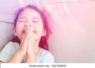 Little Girl Praying Worship GOD At Home.Little Asian Girl Hand Praying For Thank GOD,Hands Folded In Prayer Concept For Faith, Spirituality And Religion.kid Girl With Holy Spirit In Pentecost Day.