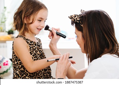 Little Girl Is Prepared For A Photo Shoot, Makeup Artist At Work. High Quality Photo