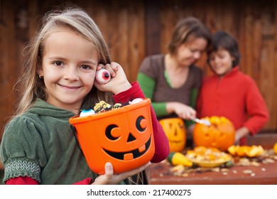 Little Girl Preparing For The Halloween Night With Her Family