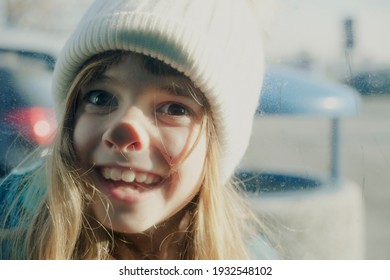 A Little Girl Pressing Her Nose Against A Dirty Glass. Winter, Outdoors, Funny, Closeup Shot.
