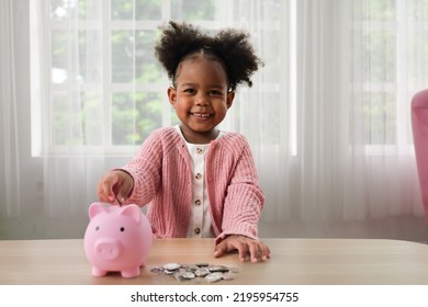 Little girl putting coin of cash into ceramic piggy bank, Happy daughter saving money for future into piggy bank - Shutterstock ID 2195954755