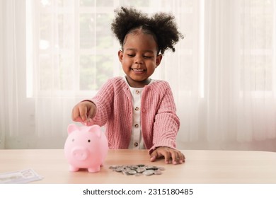 Little girl putting coin of cash into ceramic piggy bank - Shutterstock ID 2315180485