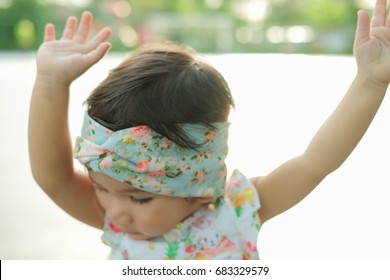 Little girl raise their hands to praise God.spirituality and religion.