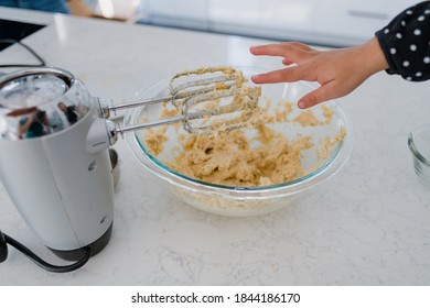 Little Girl Reaching For A Taste Of Cookie Dough