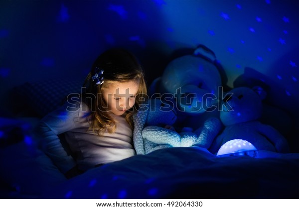 Little Girl Reading Book Bed Dark Stock Photo Edit Now 492064330