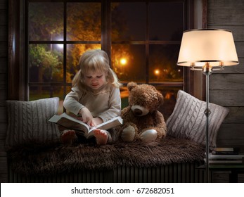 little girl reads a book, drives a finger over the lines. The child is sitting with a Teddy bear. Cozy children room, beautiful window, evening